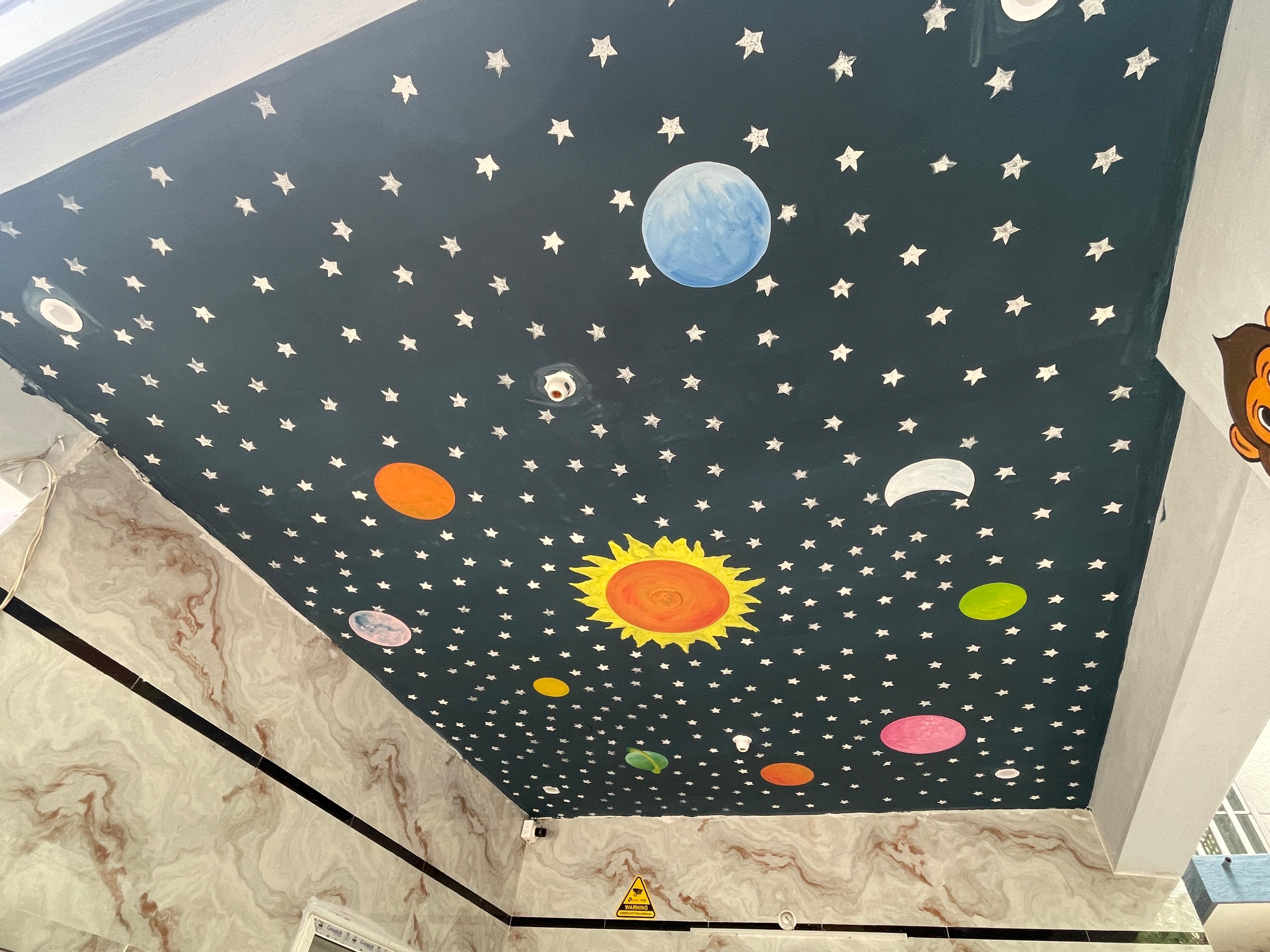Space themed ceiling at Pravish Preschool